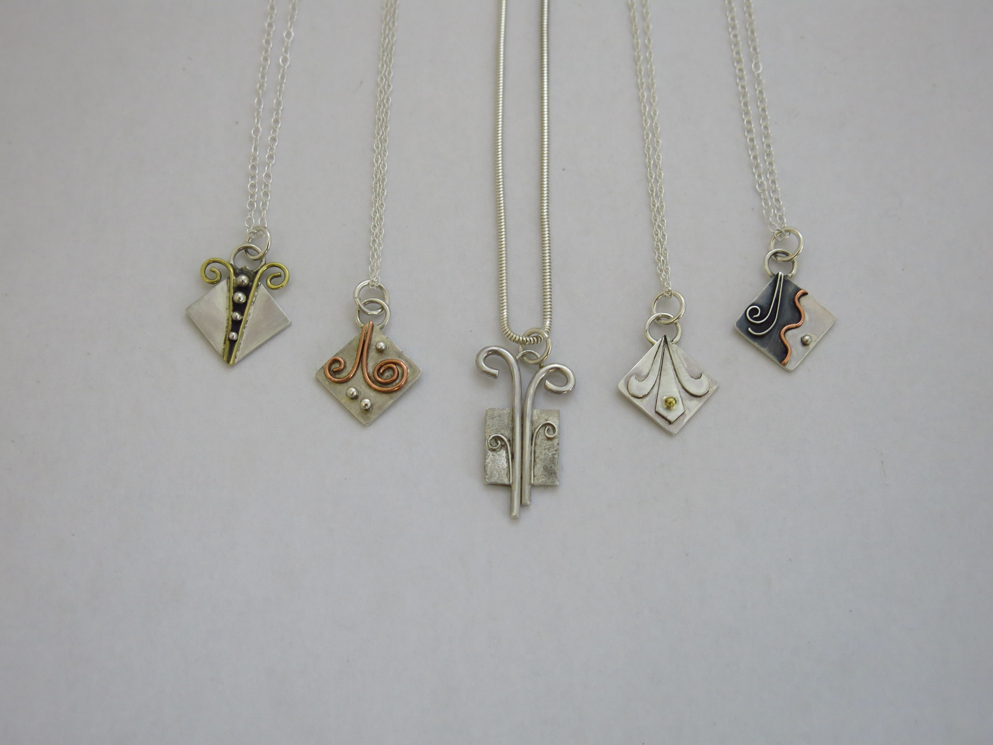 Silver pendants with silver,copper and brass