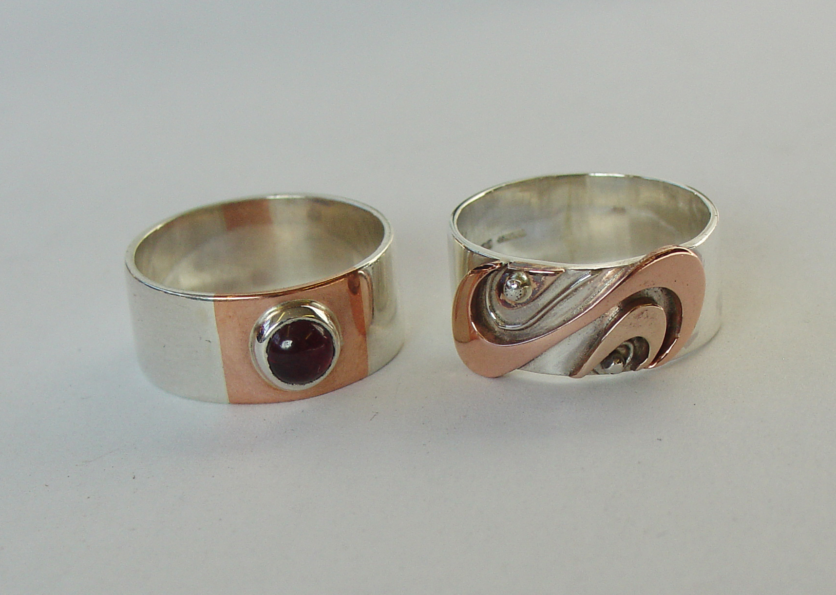 Silver, copper and garnet rings