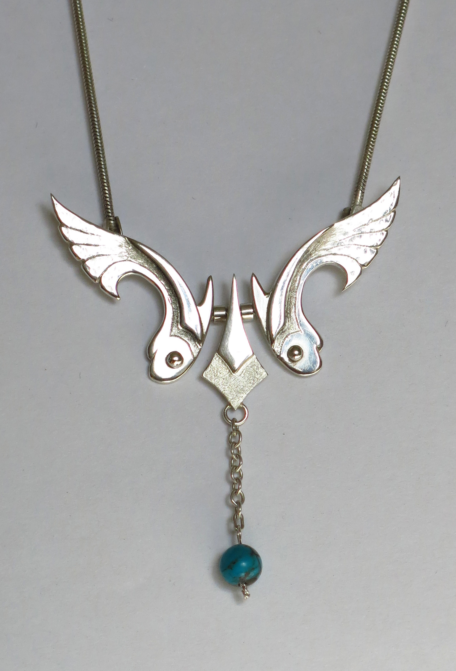 Silver fish with turquoise