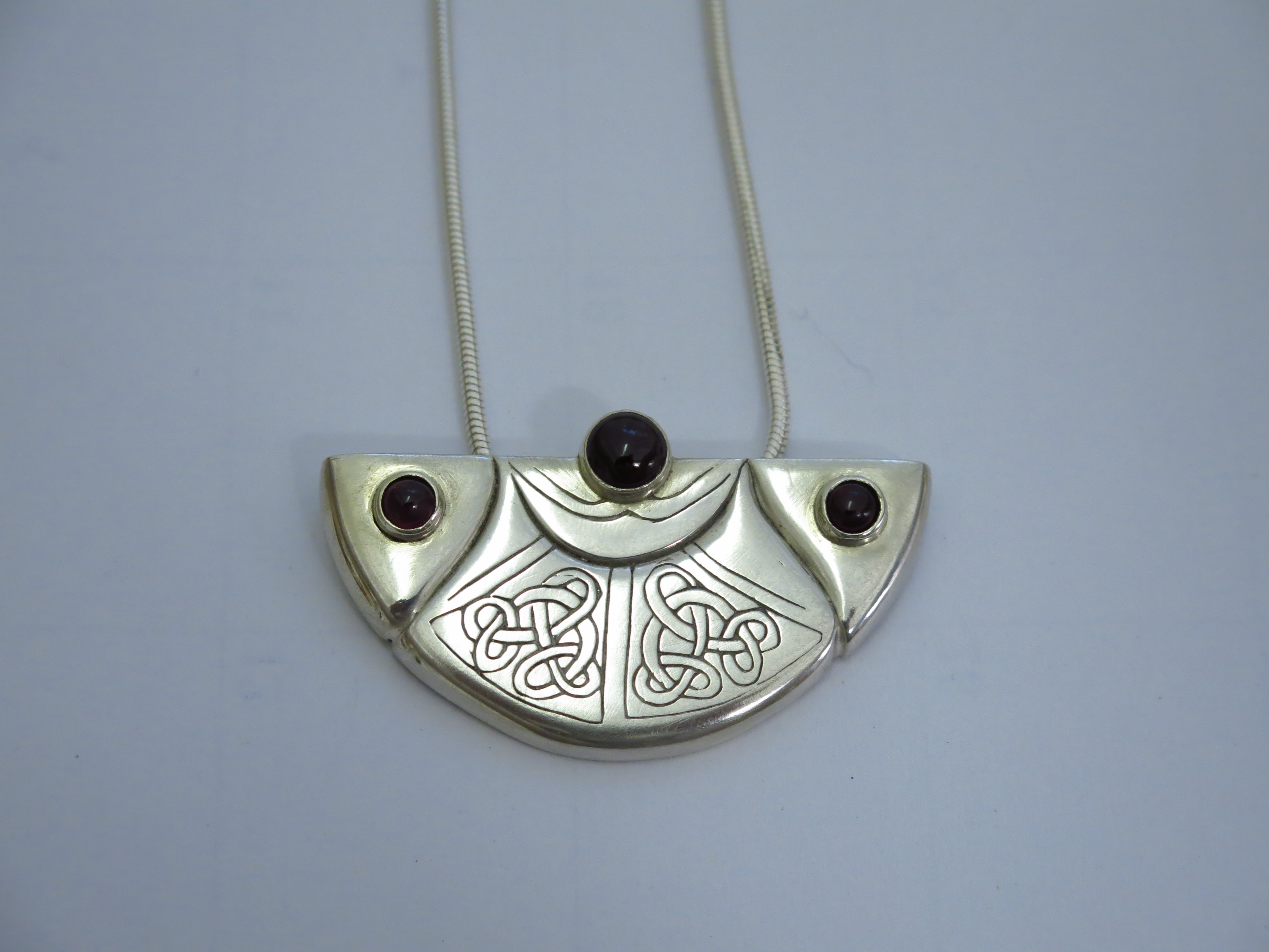 Silver pendant with garnet