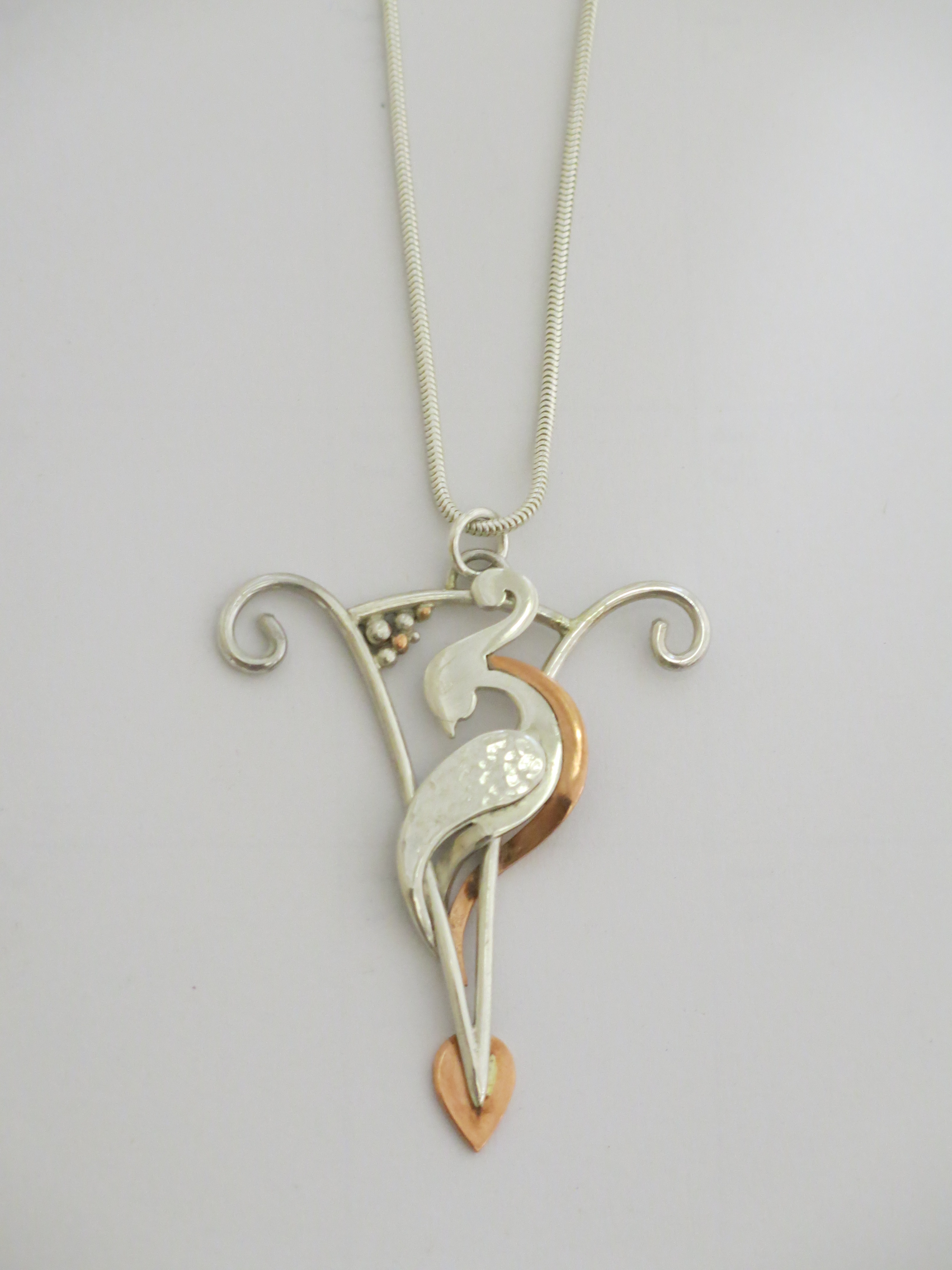 Silver and copper bird pendant