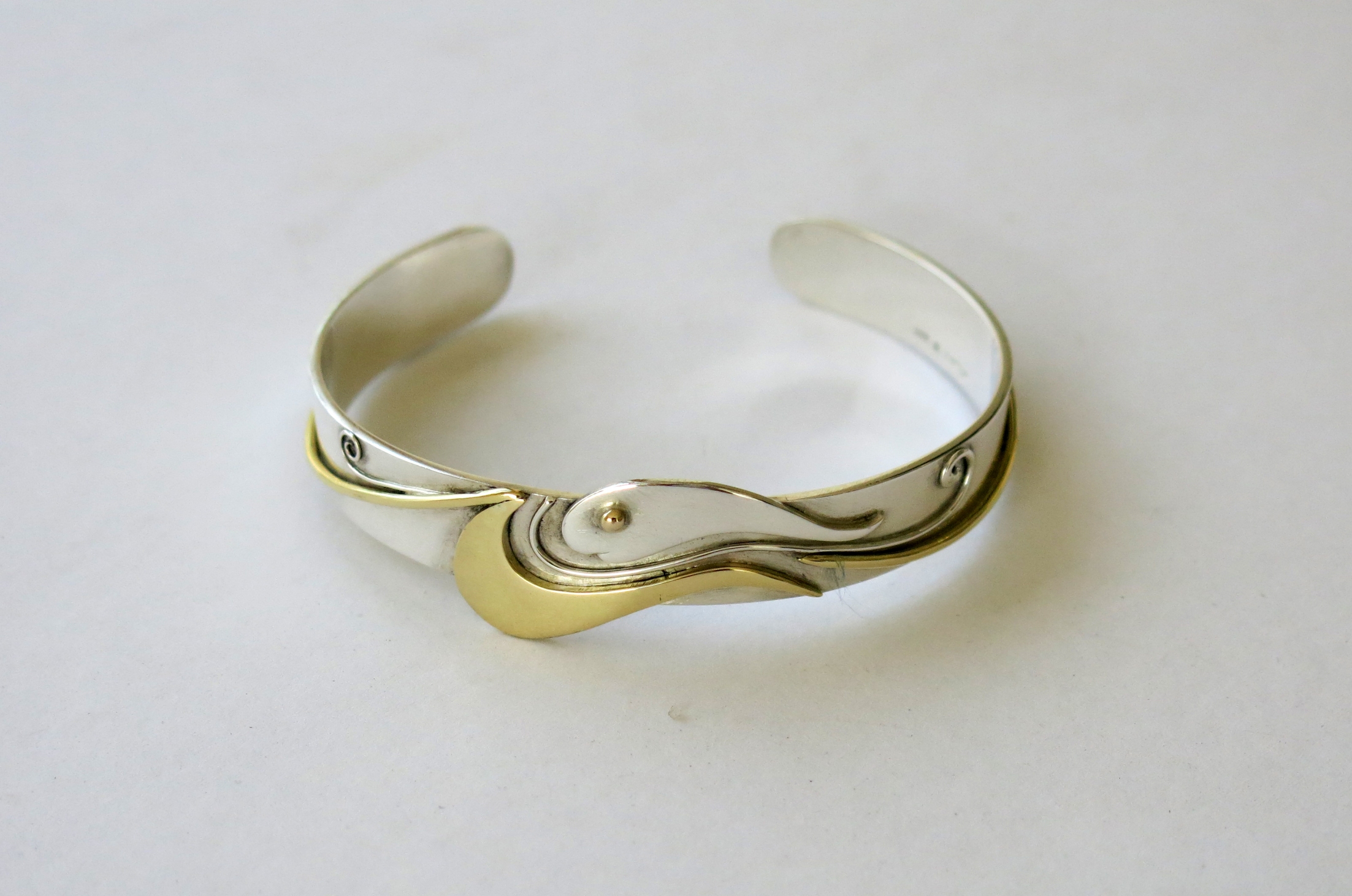 Silver and brass fish bangle