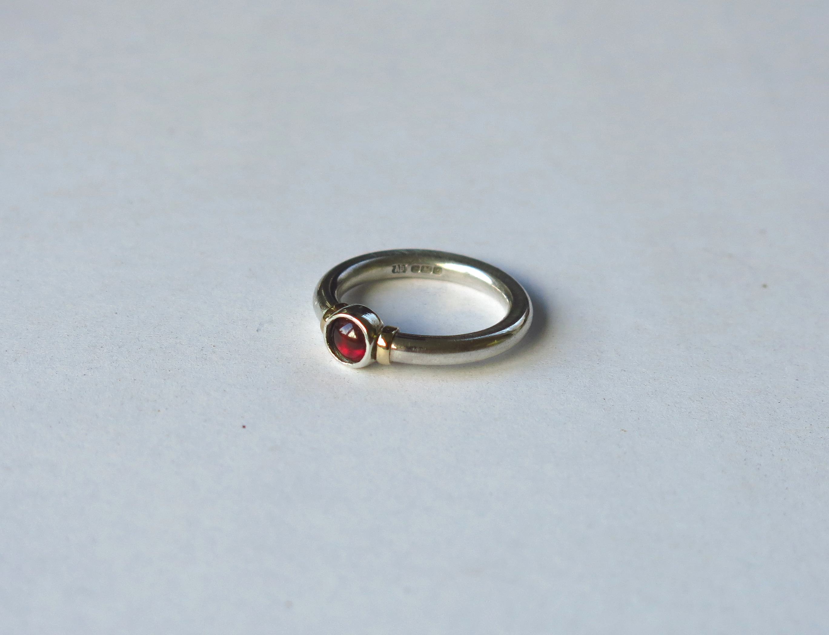 Silver, gold and garnet ring