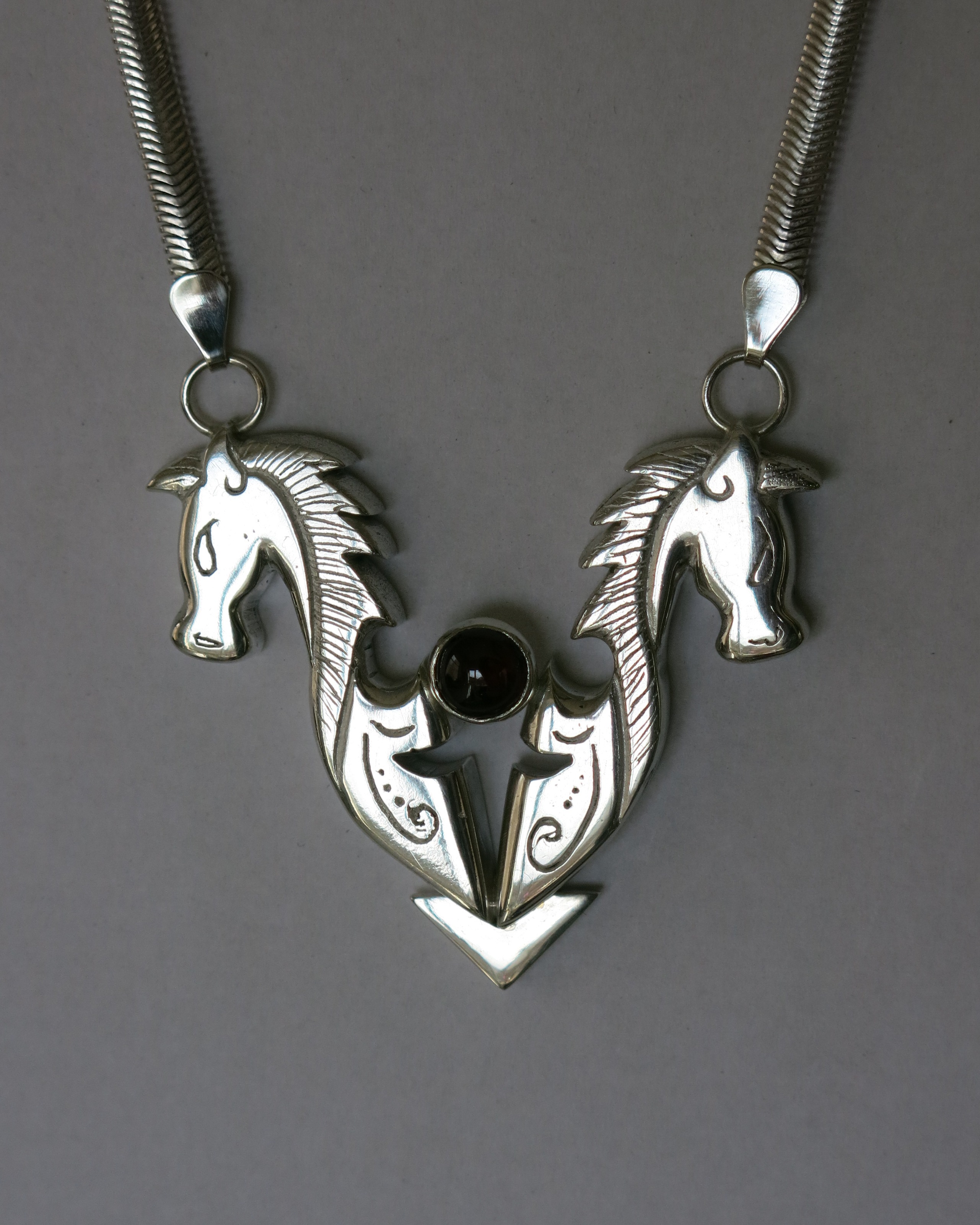 one-off cast horses set with garnet