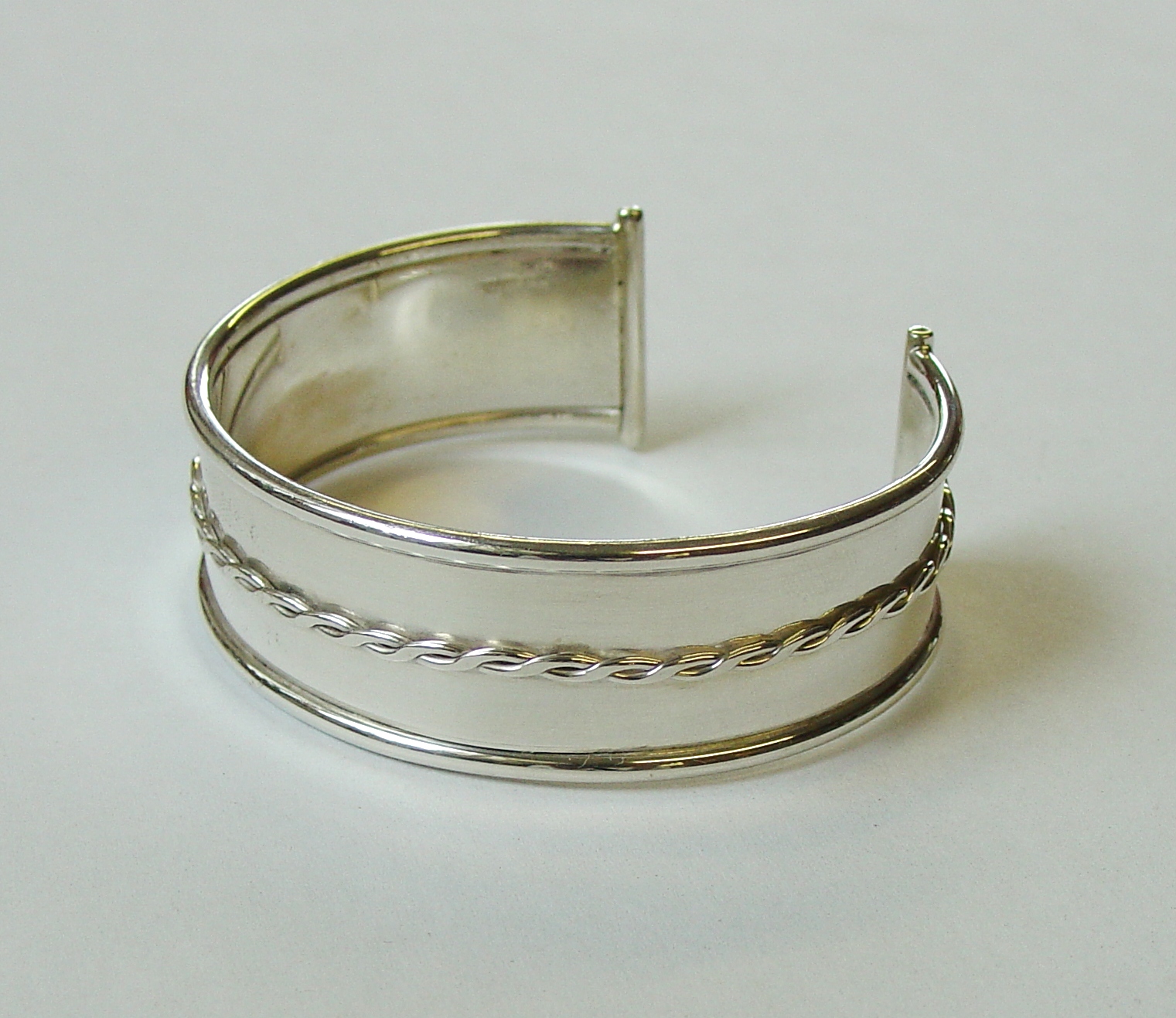 Chunky silver bangle with silver wire twist detail