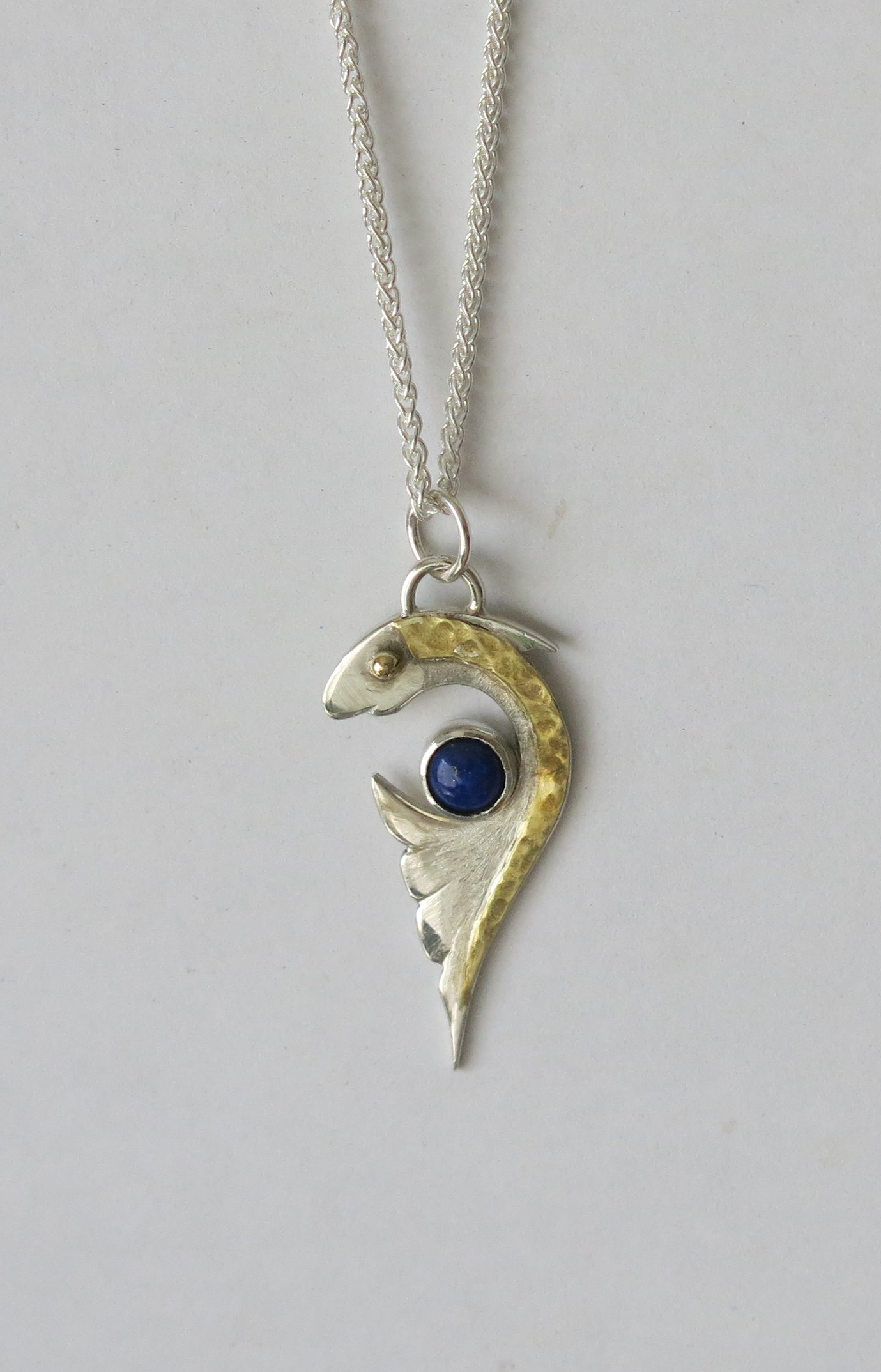 Silver and brass fish with lapis lazuli